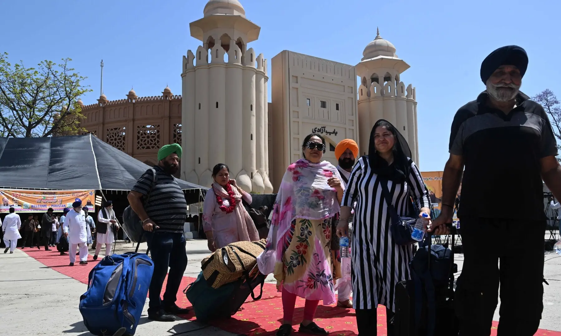 The Sikh pilgrims carry their luggage as they arrive in Pakistan from India via Wagah border on April 10, 2026. &mdash; White Star/ Arif Ali