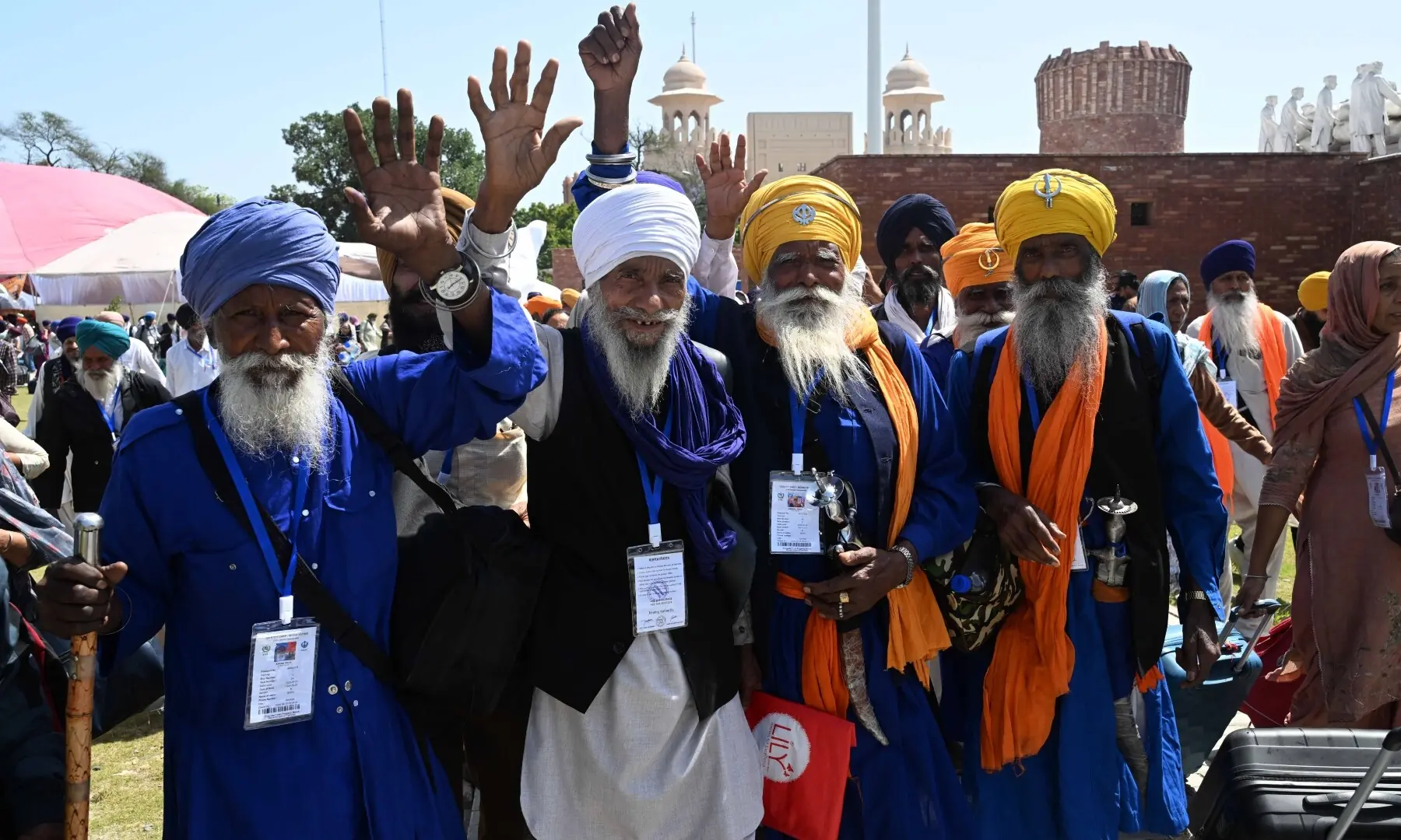 Sikh pilgrims wave as they arrive in Pakistan from India via Wagah border on April 10, 2026. &mdash; White Star/ Arif Ali