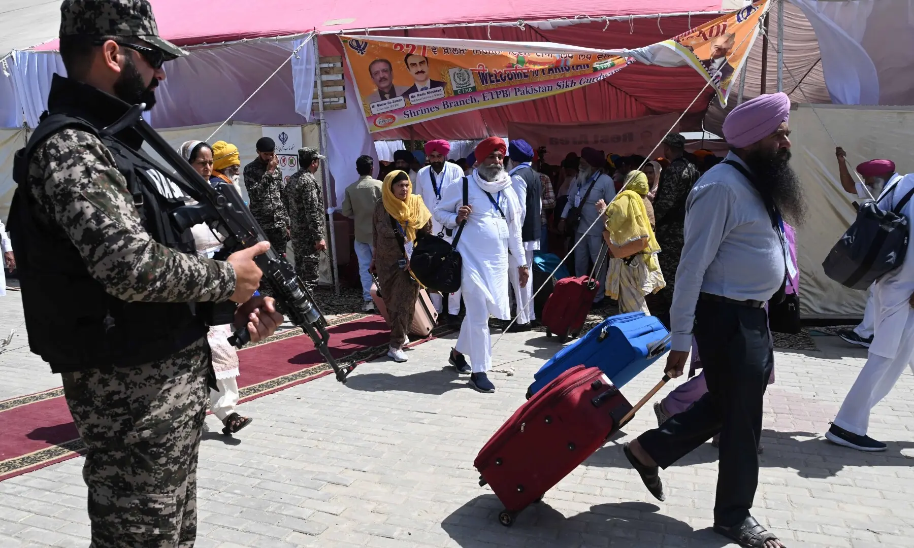 A soldier stands guard as the first batch of Sikh pilgrims arrives from India to Pakistan via Wagah border on April 10, 2026. &mdash; White Star/Arif Ali