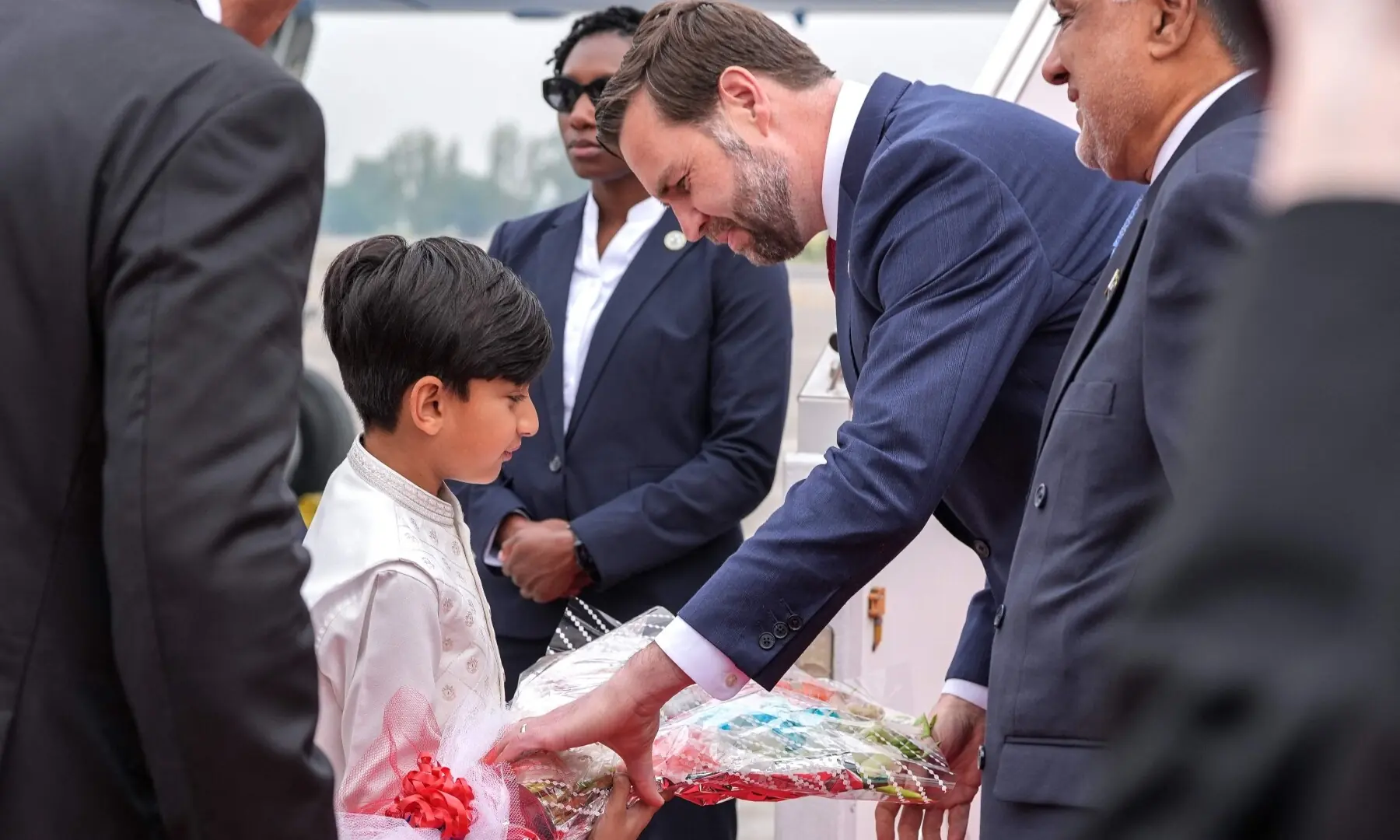 US Vice President JD Vance receives a bouquet after arriving for the US-Iran peace talks in Islamabad on April 11, 2026. &mdash;AFP