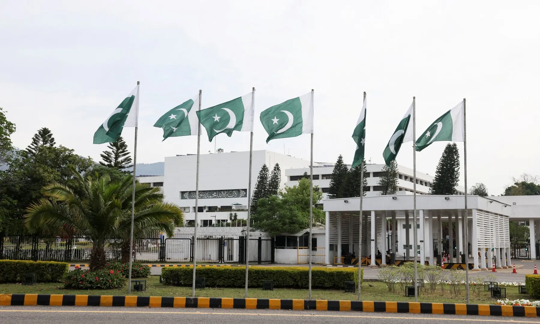 Pakistani flags flutter near the Parliament House, as delegations from the United States and Iran are expected to hold peace talks, in Islamabad, Pakistan, April 11, 2026. &mdash;Reuters