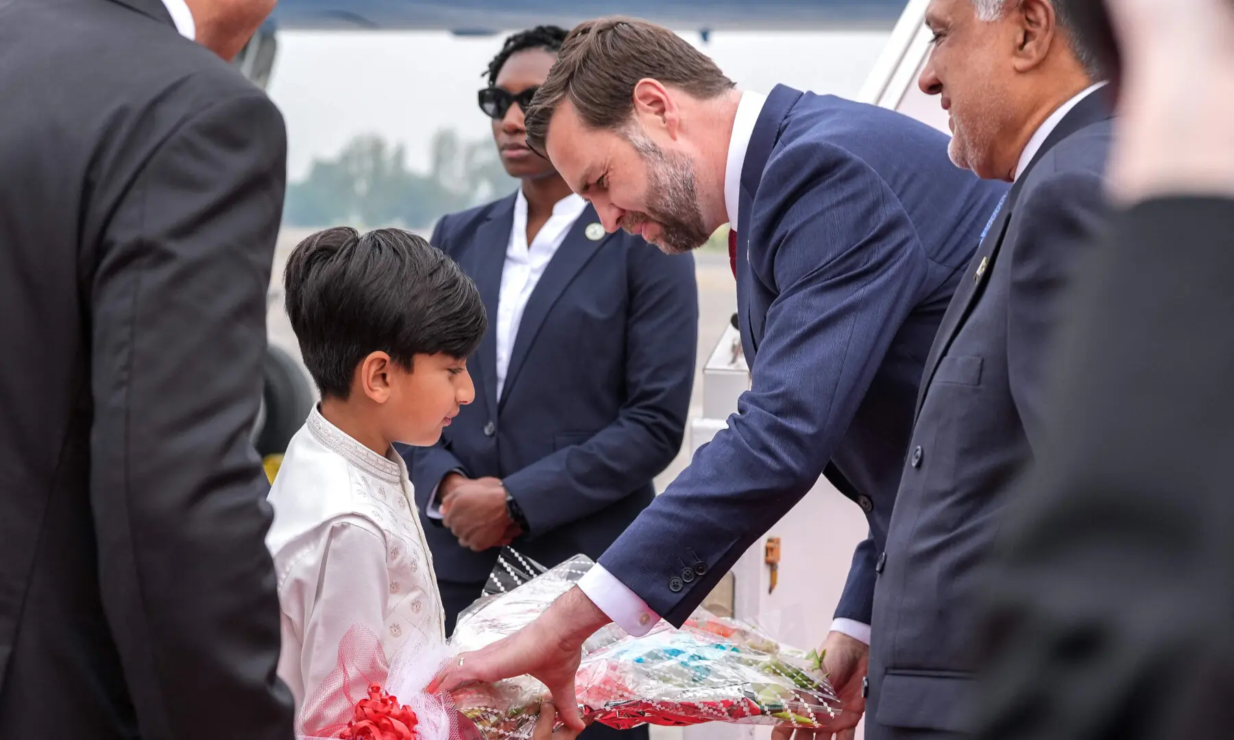 US Vice President JD Vance (2R) receives a bouquet after arriving for the US-Iran peace talks in Islamabad on April 11, 2026. &mdash; AFP