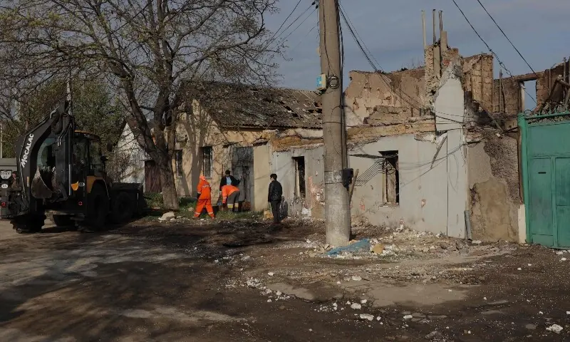 Communal workers clean debris next to a destroyed house following an air attack in Odesa on April 11, amid the Russian invasion in Ukraine. — AFP Communal workers clean debris next to a destroyed house following an air attack in Odesa on April 11, amid the Russian invasion in Ukraine. — AFP