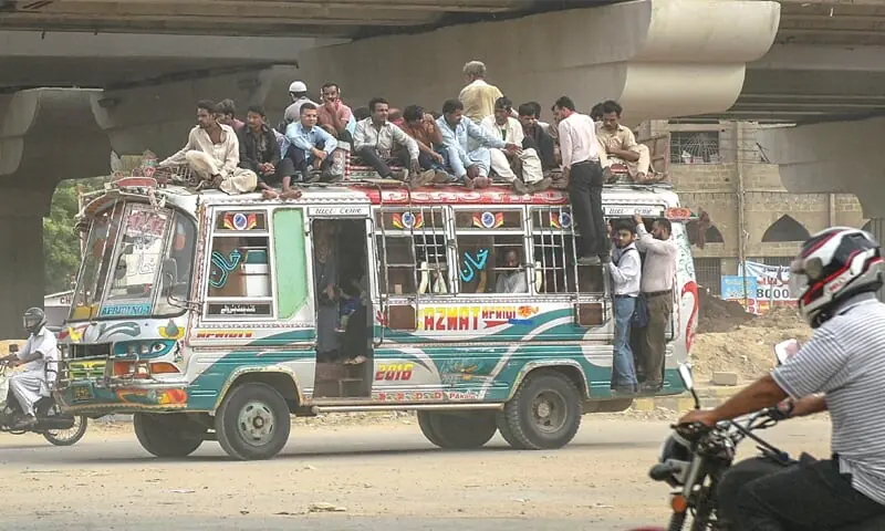 This undated image shows an overcrowded minibus, known as a coach, running on a road in Karachi. —White Star This undated image shows an overcrowded minibus, known as a coach, running on a road in Karachi. —White Star