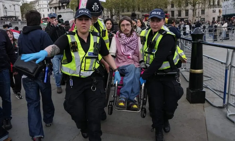 Police remove a protester (C) as people gather to call for the lifting of the ban on the Palestine Action group during a demonstration in Trafalgar Square in central London on April 11, 2026. — AFP Police remove a protester (C) as people gather to call for the lifting of the ban on the Palestine Action group during a demonstration in Trafalgar Square in central London on April 11, 2026. — AFP
