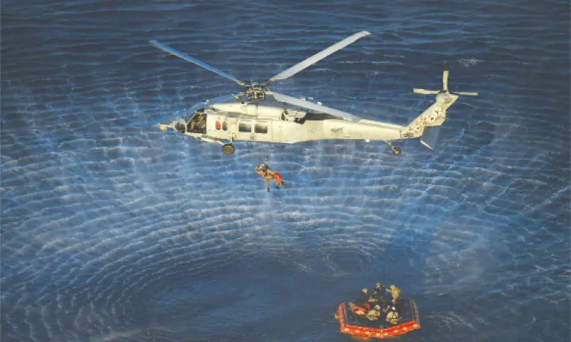 An astronaut being hoisted into a US Navy helicopter after successfully splashing down in the Pacific Ocean.&mdash;AFP
