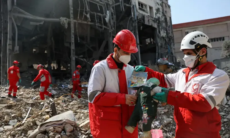 Members of a Red Crescent rescue team hold a doll, at the site of a building that was damaged by a strike, amid the US-Israeli conflict with Iran, in Tehran, Iran, on March 17, 2026. — Reuters Members of a Red Crescent rescue team hold a doll, at the site of a building that was damaged by a strike, amid the US-Israeli conflict with Iran, in Tehran, Iran, on March 17, 2026. — Reuters