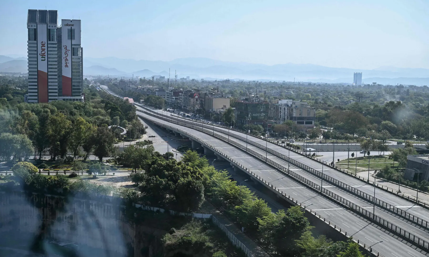 A deserted road is pictured after authorities restricted movement for the US-Iran peace talks in Islamabad on April 12, 2026. &mdash; AFP
