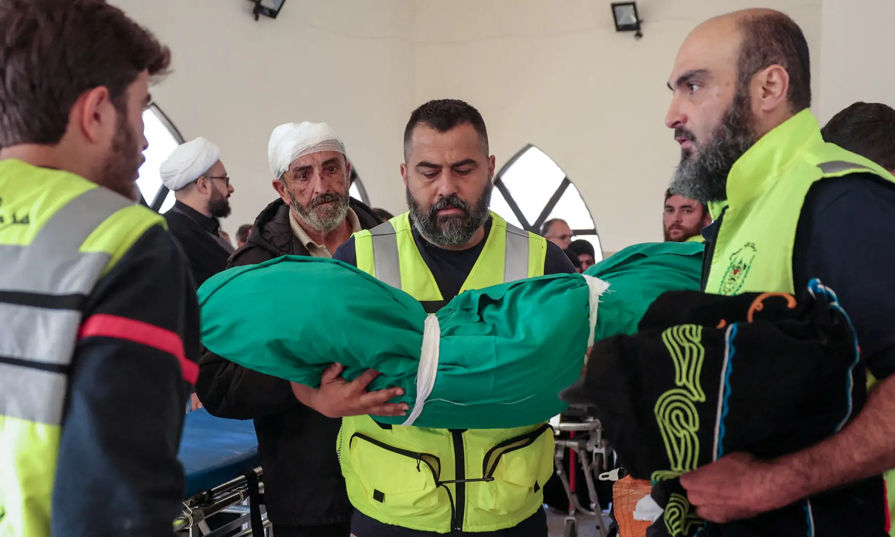 A member of civil defence personnel holds the body of Taleen Saeed, 1.5 years old, killed in an Israeli strike in the village of Srifa on Wednesday along with three other members of her family, at the Al Kharab mosque in Tyre, Lebanon, April 12, 2026. &mdash; Reuters