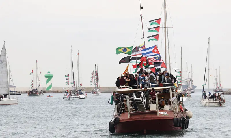 BOATS of a new humanitarian flotilla bound for the Gaza Strip make a symbolic leave from Barcelona’s Port Vell on Sunday as its departure was postponed due to bad weather.—AFP BOATS of a new humanitarian flotilla bound for the Gaza Strip make a symbolic leave from Barcelona’s Port Vell on Sunday as its departure was postponed due to bad weather.—AFP