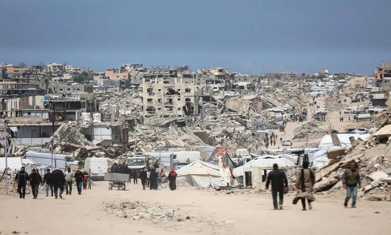 Palestinians walk amid the rubble of destroyed buildings in Jabalia refugee camp, northern Gaza Strip.—AFP Palestinians walk amid the rubble of destroyed buildings in Jabalia refugee camp, northern Gaza Strip.—AFP