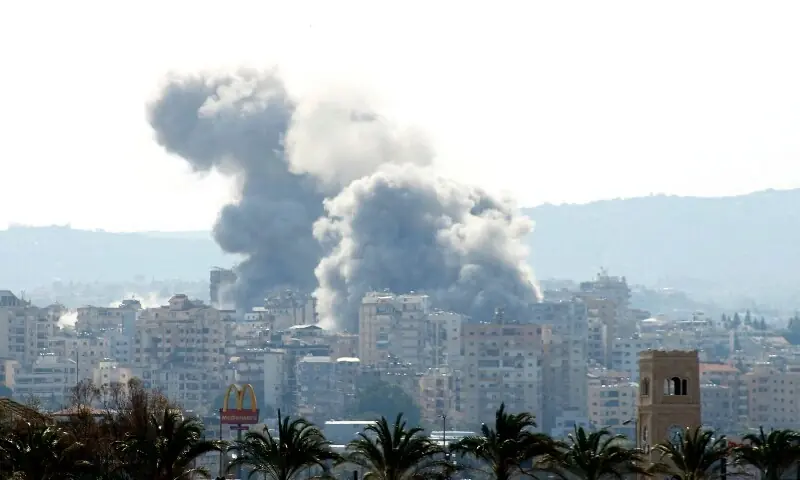 Smoke rises behind palm trees and a McDonald&rsquo;s &ldquo;Golden Arches&rdquo; logo from the site of an Israeli airstrike that targeted the Al-Hosh area near the coastal Lebanese city of Tyre on April 14, 2026. &mdash;AFP