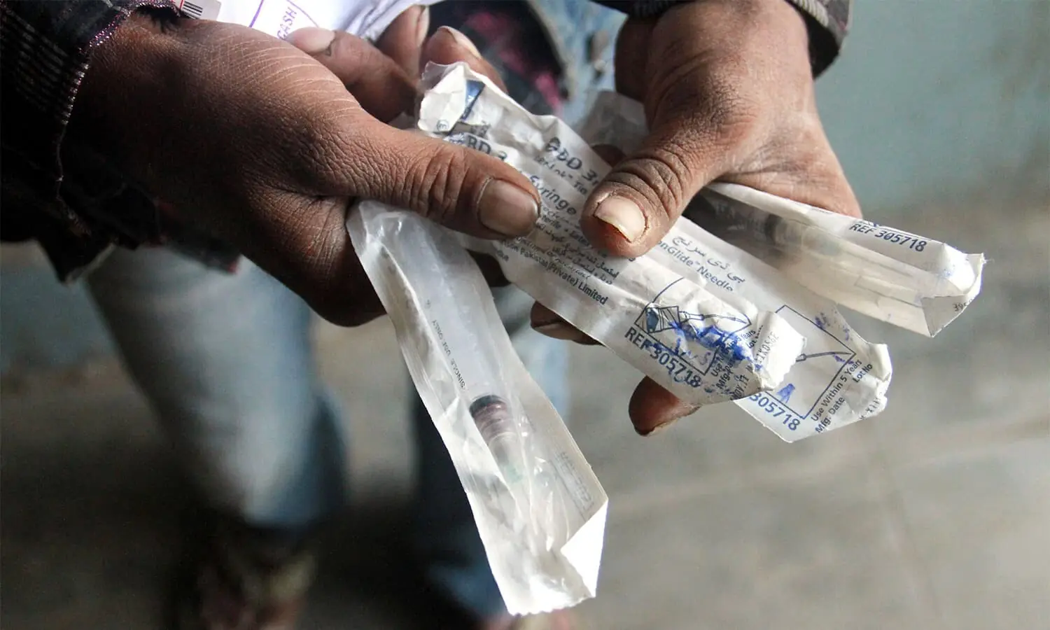 This representational image shows a man holding syringes. &mdash; Dawn/ File