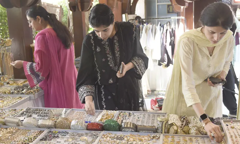 Visitors look at rings on display during the Craft Festival in Islamabad on Tuesday. &mdash; Photo by Tanveer Shahzad