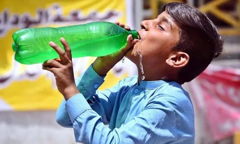 A boy drinks cold water to quench his thirst amid heatwave in Hyderabad. — APP/File A boy drinks cold water to quench his thirst amid heatwave in Hyderabad. — APP/File