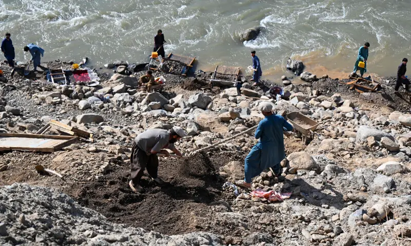 This photograph taken on April 13, 2026 shows Afghan men digging a mountainside along the Kunar riverbed before seiving stones in search of gold nuggets in the Song area of Ghaziabad district, Kunar province. Hundreds of men dig into the riverbed in the mountainous province of Kunar in eastern Afghanistan, searching for a few grams of gold dust, which is heavier than sand. At the foot of imposing peaks, some of which were still covered in snow in April, the Kunar River flowed through the province bordering Pakistan. &mdash; AFP