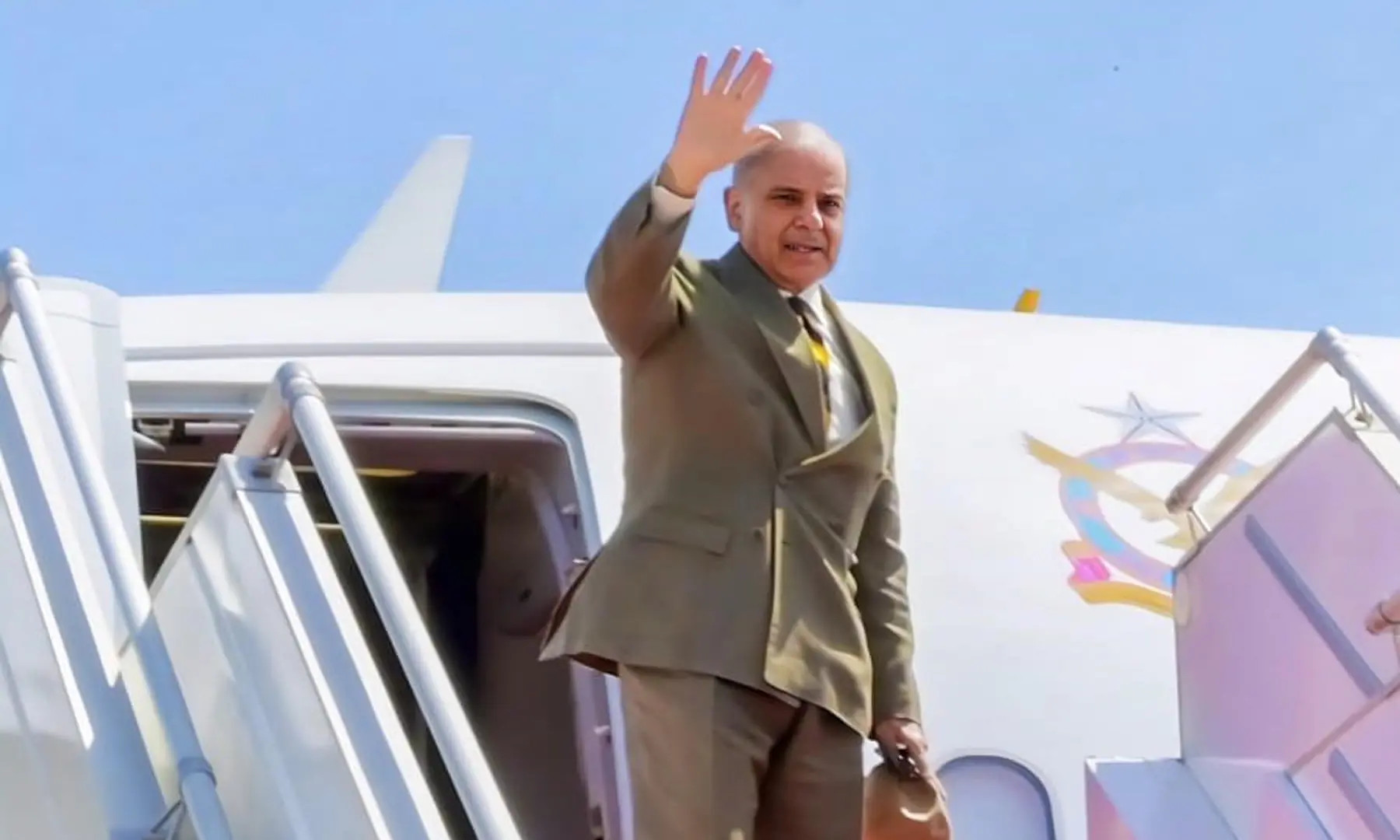 Prime Minister Shehbaz Sharif waves as he departs Nur Khan airbase in Rawalpindi on April 15, 2026. &mdash; PID