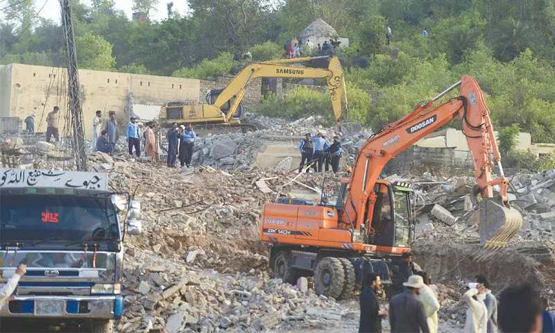 Excavators are being used to raze structures at Noorpur Shahan in Islamabad as CDA’s anti-encroachment operation continued on Wednesday. — Photo by Mohammad Asim Excavators are being used to raze structures at Noorpur Shahan in Islamabad as CDA’s anti-encroachment operation continued on Wednesday. — Photo by Mohammad Asim