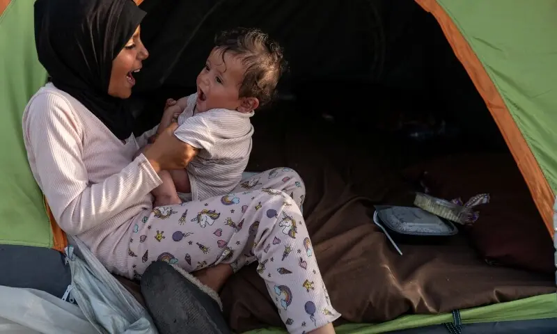 Jana, 9, a displaced girl who fled south Lebanon following Israeli evacuation orders, plays with her brother Jad, 5 months old, at a makeshift encampment in Beirut, Lebanon, April 15, 2026. &mdash;Reuters