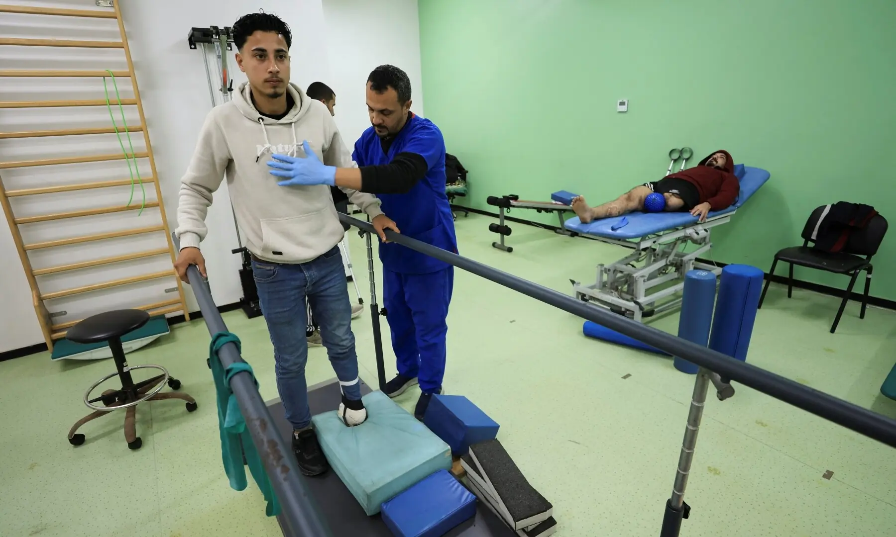 Palestinian amputee Ahmed Al-Tanani undergoes rehabilitation training on a walking device at the Sheikh Hamad bin Khalifa Al-Thani Rehabilitation and Prosthetics Hospital, in Gaza City on April 2, 2026. &mdash; Reuters