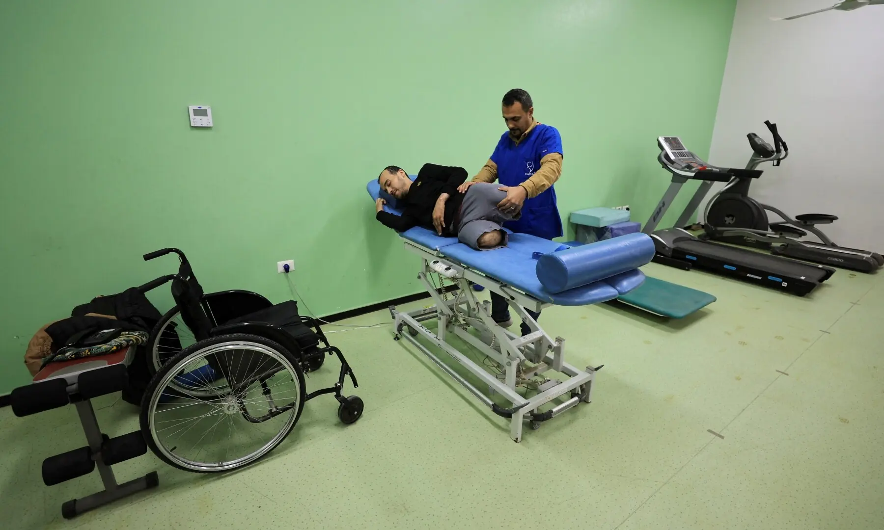 Palestinian amputee Omar Abu Ali, 34, who was injured in an Israeli strike, undergoes a therapy session assisted by a medical worker at Sheikh Hamad bin Khalifa Al-Thani Rehabilitation and Prosthetics Hospital, in Gaza City on March 31, 2026. &mdash; Reuters