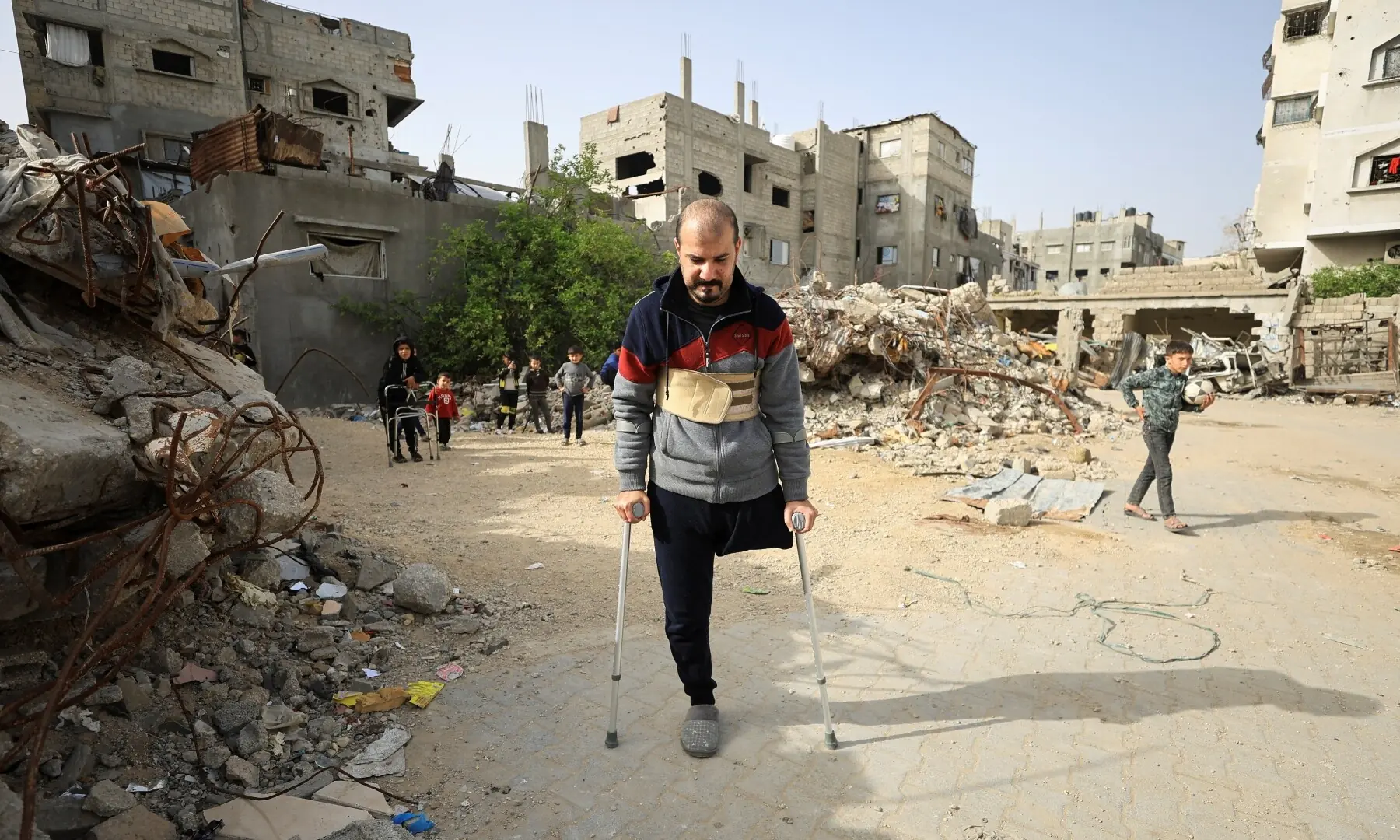 Palestinian amputee Hazem Foura, who lost one leg, walks using crutches in a street in Gaza City on April 3, 2026. —Reuters Palestinian amputee Hazem Foura, who lost one leg, walks using crutches in a street in Gaza City on April 3, 2026. —Reuters
