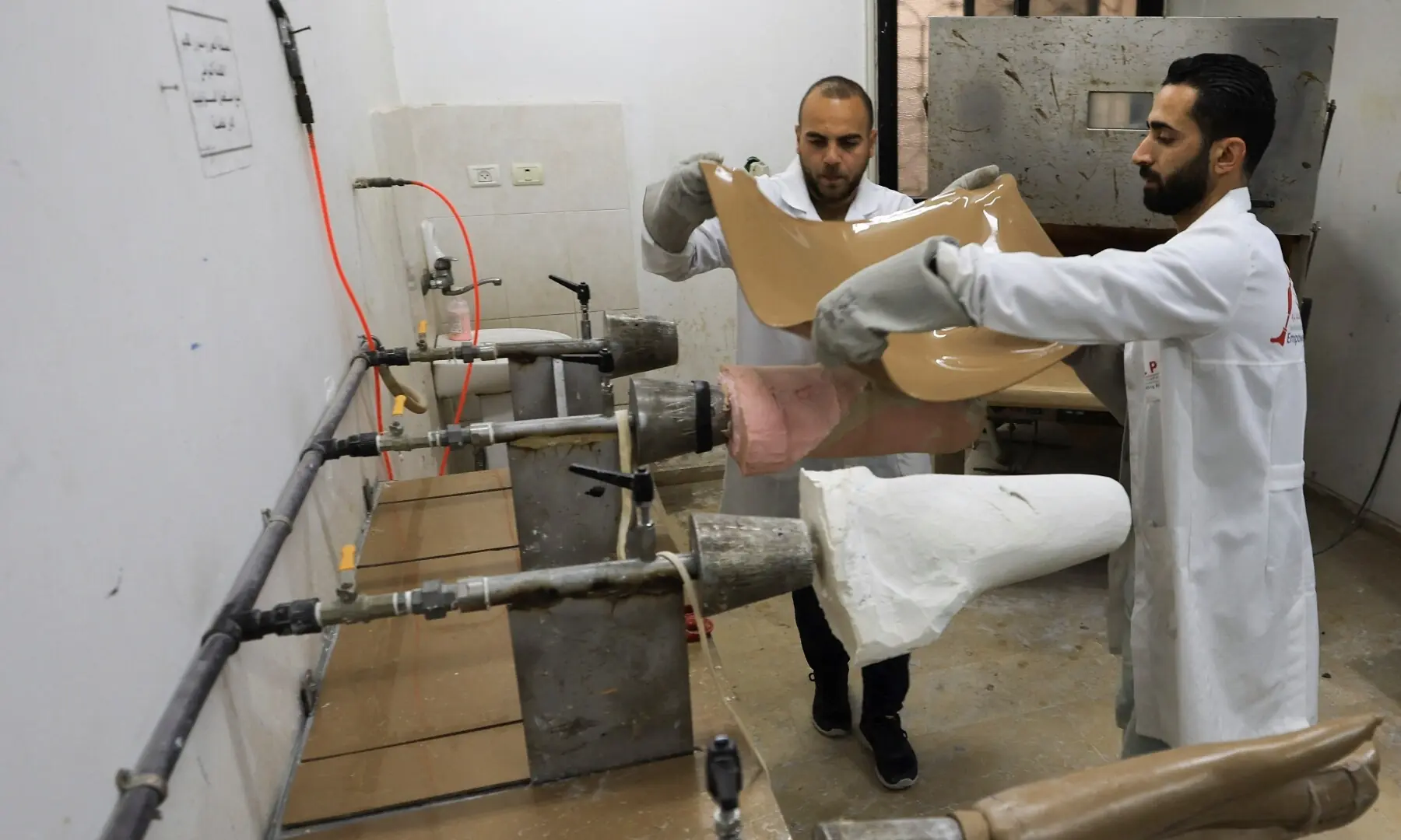 Palestinian workers assemble prosthetic limbs at a workshop, using materials such as plastic components and gypsum, amid shortages of essential supplies, in Gaza City on April 7, 2026. &mdash; Reuters