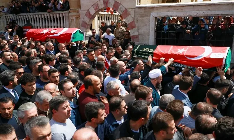 People carry the coffins of the victims of a school shooting during their funeral prayers at a mosque in Kahramanmaras, Turkiye on April 16, 2026. &mdash; Reuters