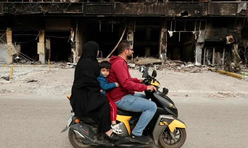 Displaced residents drive past a damaged building as they return temporarily to inspect their homes, after a 10-day ceasefire between Lebanon and Israel went into effect, in the southern suburbs of Beirut, Lebanon, April 17, 2026. &mdash;Reuters