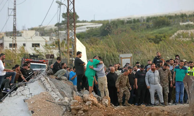 People watch the restoration work at the site of Israeli strikes that targeted the Qasmieh bridge built over the Litani river in the southern Lebanese area of Al Qasmiyeh on April 17, 2026, as displaced residents prepare to travel back to their homes. &mdash; AFP