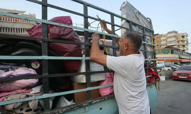 A displaced resident packs his belongings as he prepares to travel back to his village home, in the southern Lebanese city of Sidon on April 17, 2026. &mdash; AFP