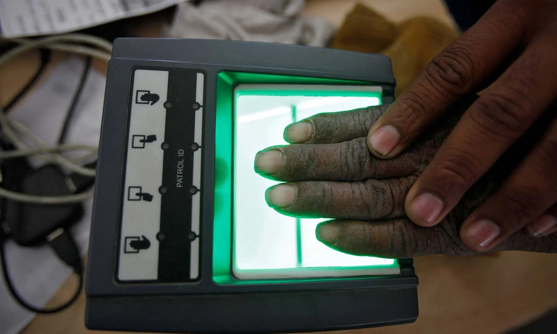 A villager goes through the process of a fingerprint scanner for the Unique Identification (UID) database system at an enrolment centre at Merta district in the desert Indian state of Rajasthan February 22, 2013. — Reuters A villager goes through the process of a fingerprint scanner for the Unique Identification (UID) database system at an enrolment centre at Merta district in the desert Indian state of Rajasthan February 22, 2013. — Reuters