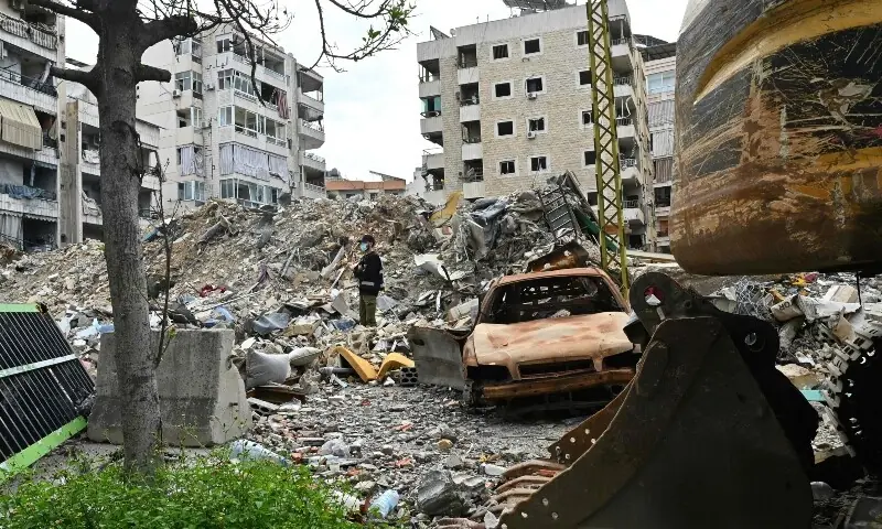 A man stands on top of rubble as Lebanese residents return to their neighbourhood in Beirut&rsquo;s southern suburbs after a 10-day ceasefire with Israel came into effect on April 17, 2026. &mdash;AFP