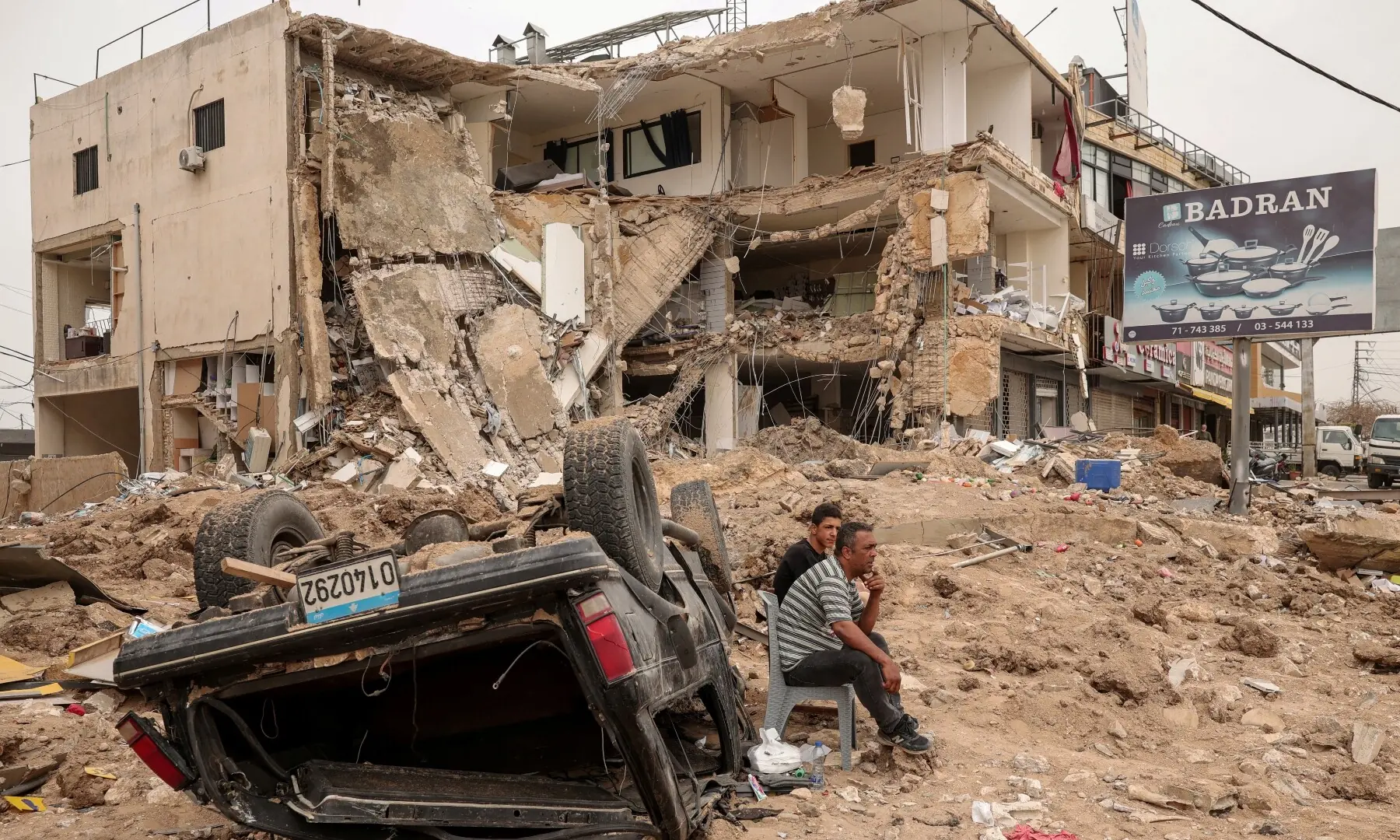 People sit at the site of an Israeli strike carried out just before a 10-day ceasefire between Lebanon and Israel went into effect, in the Abbassye area of Tyre, Lebanon on April 18, 2026. &mdash; Reuters