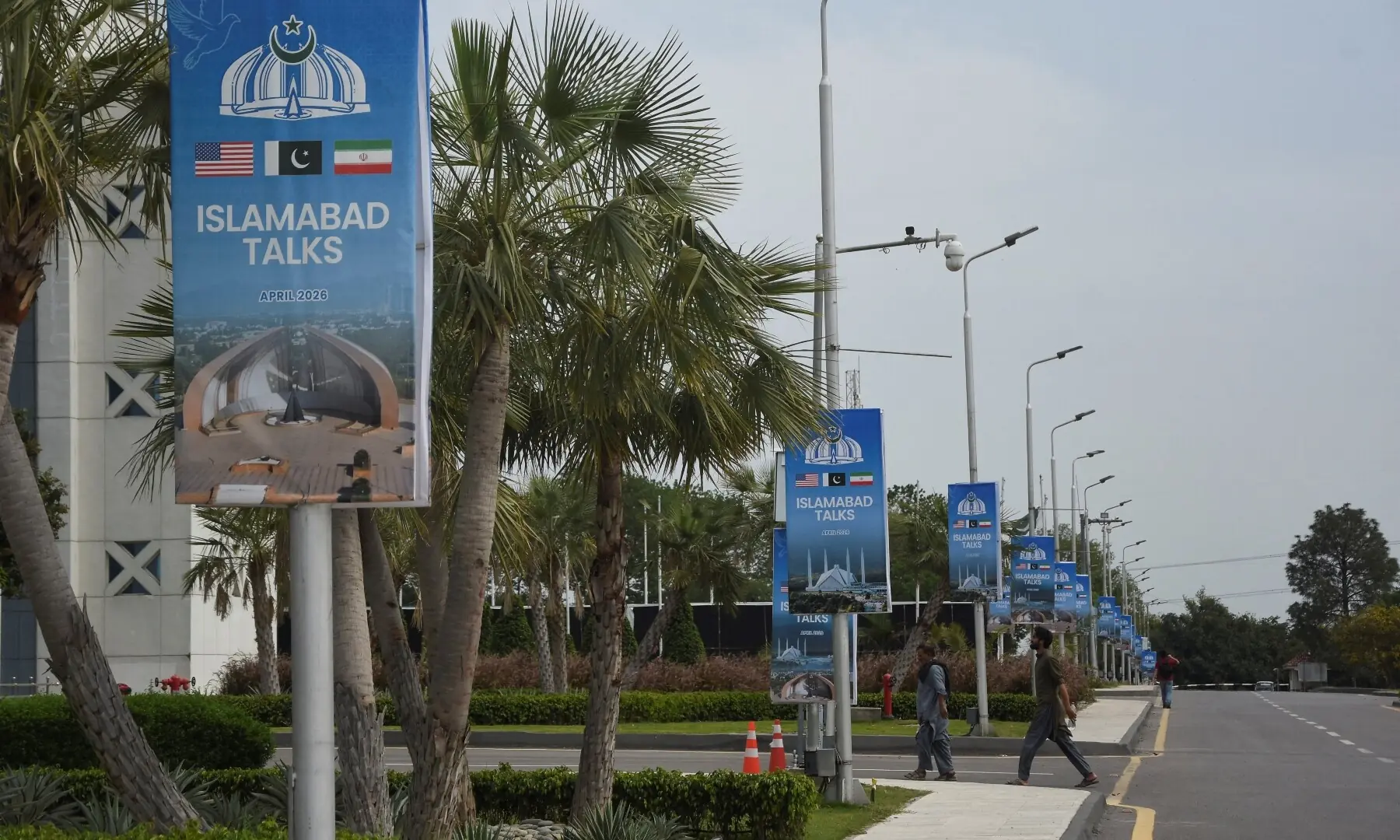 Hoardings displaying flags of the US Pakistan and Iran, as Pakistan prepares to host the US and Iran for the second phase of peace talks in Islamabad, on April 18, 2026. &mdash;Reuters