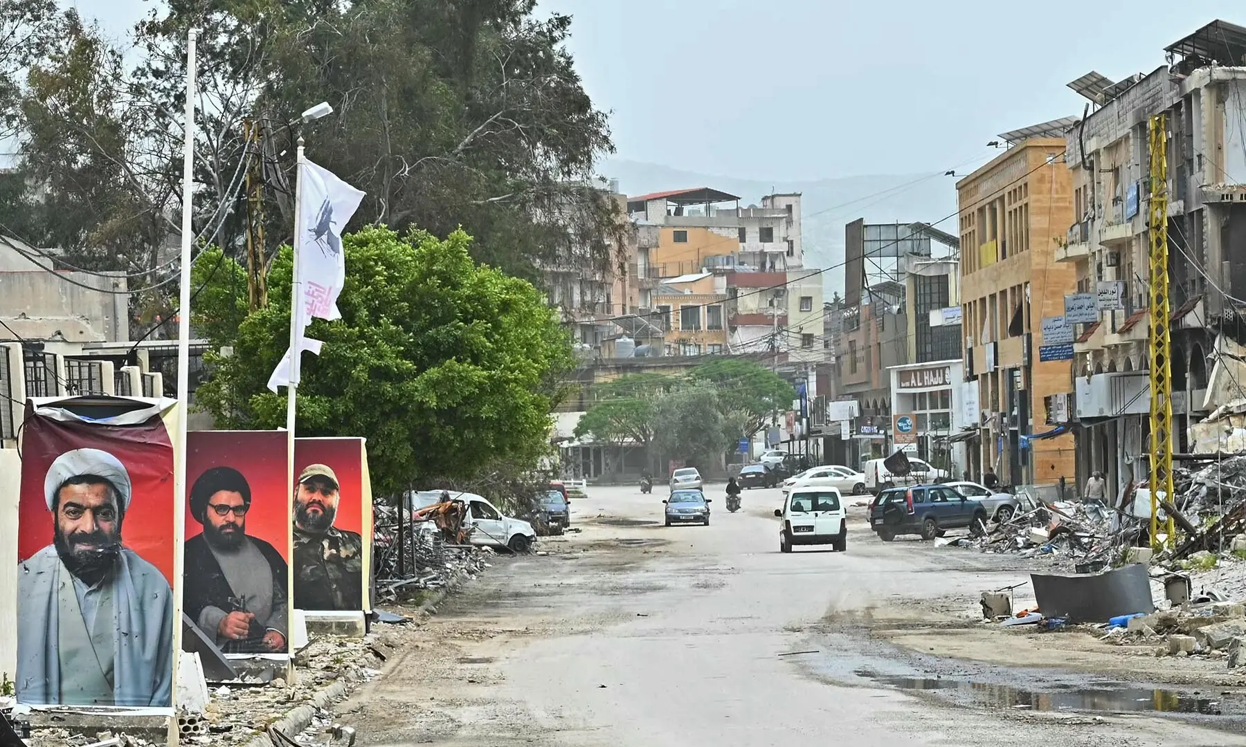 Displaced residents drive past damaged buildings as they return to the southern Lebanese city of Nabatieh on April 18, 2026. &mdash; AFP