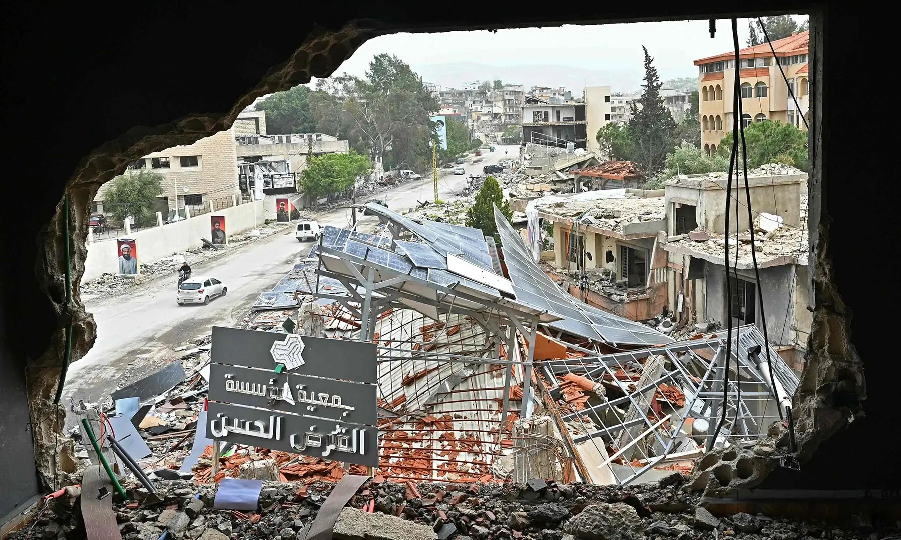 Displaced residents drive past destroyed buildings as they return to the southern Lebanese city of Nabatieh on April 18, 2026.  &mdash; AFP