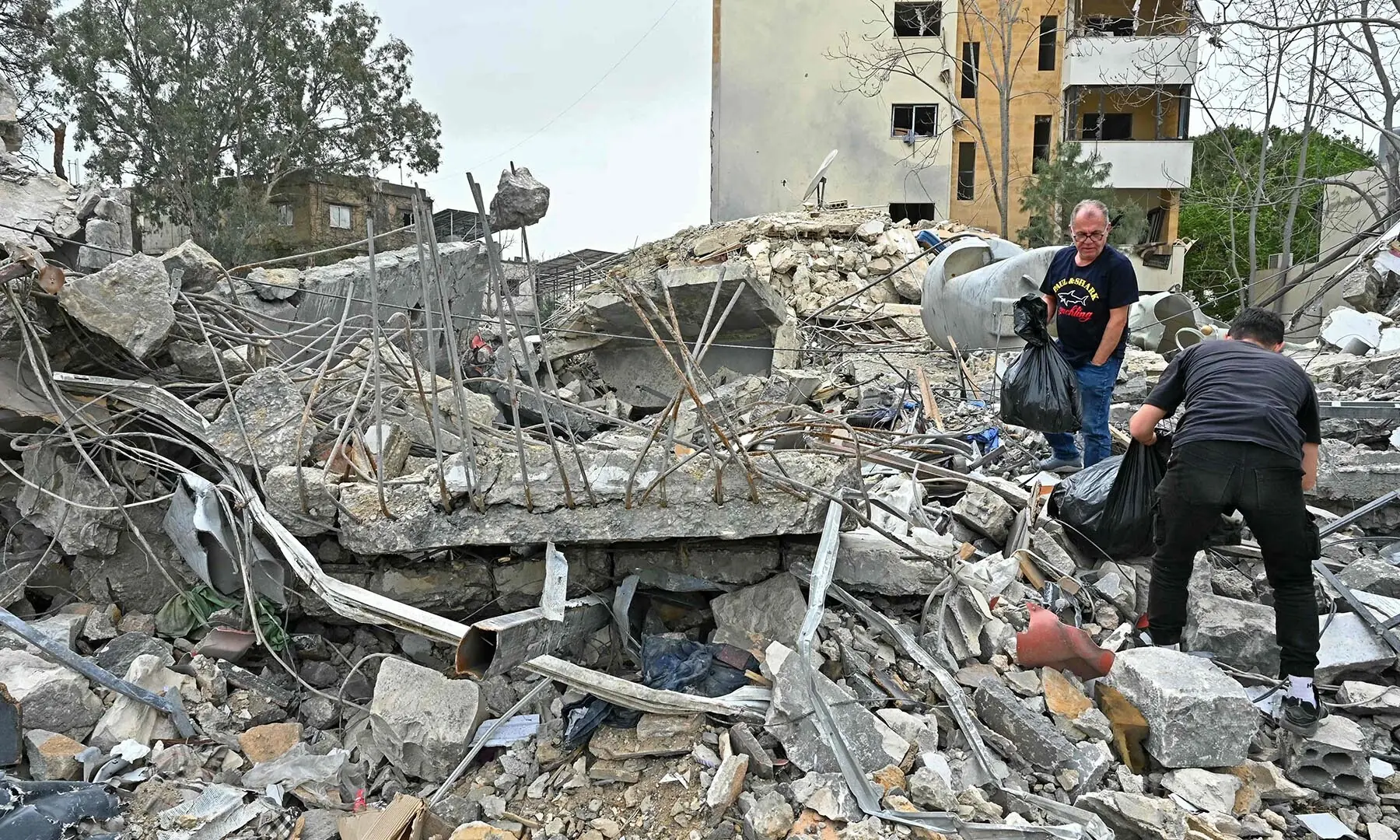 Residents inspect the rubble of a destroyed building upon their return to in the southern Lebanese city of Nabatieh on April 18, 2026. &mdash; AFP