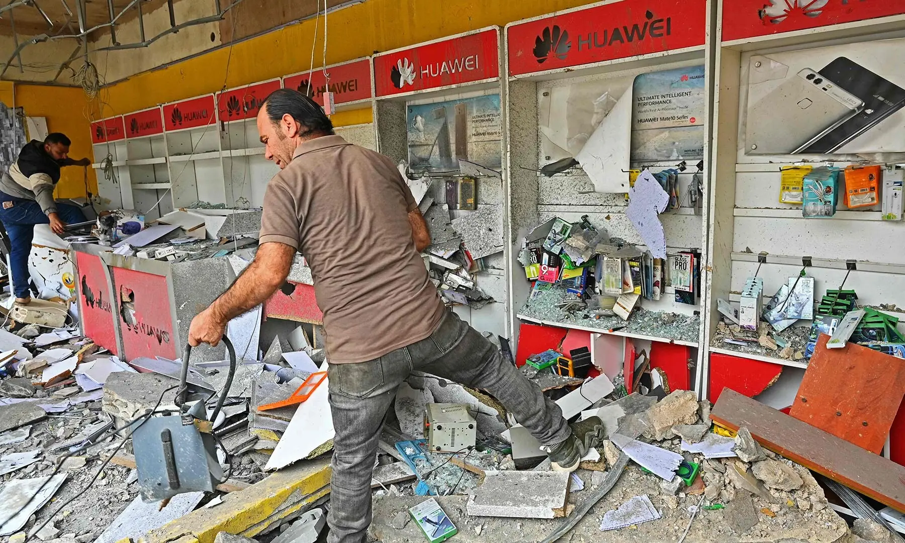 People inspect rubble in a destroyed shop upon their return to the southern Lebanese city of Nabatieh on April 18, 2026. &mdash; AFP