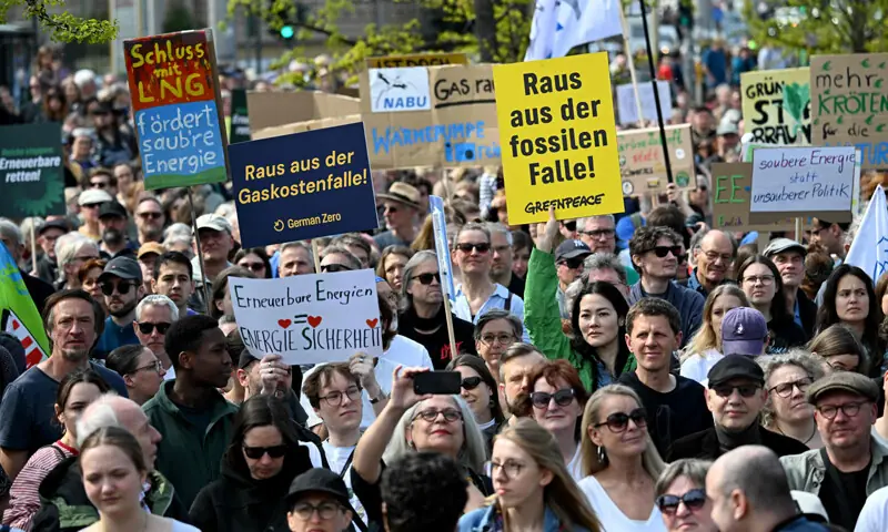Activists and supporters of environmental groups hold up placards as they protest against the German government’s energy policy in Berlin.—AFP Activists and supporters of environmental groups hold up placards as they protest against the German government’s energy policy in Berlin.—AFP