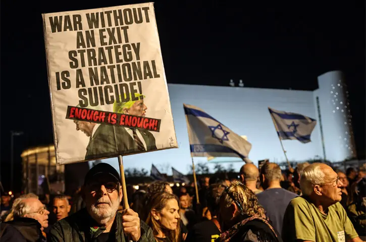 TEL AVIV: Israeli left-wing activists hold up placards during a demonstration against the ongoing war with Iran and Lebanon and against the Israeli government at HaBima Square.—AFP TEL AVIV: Israeli left-wing activists hold up placards during a demonstration against the ongoing war with Iran and Lebanon and against the Israeli government at HaBima Square.—AFP