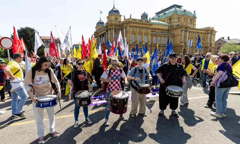 DRUMMERS perform as protesters wave flags and placards during a demonstration in Zagreb for higher wages and pensions.&mdash;AFP