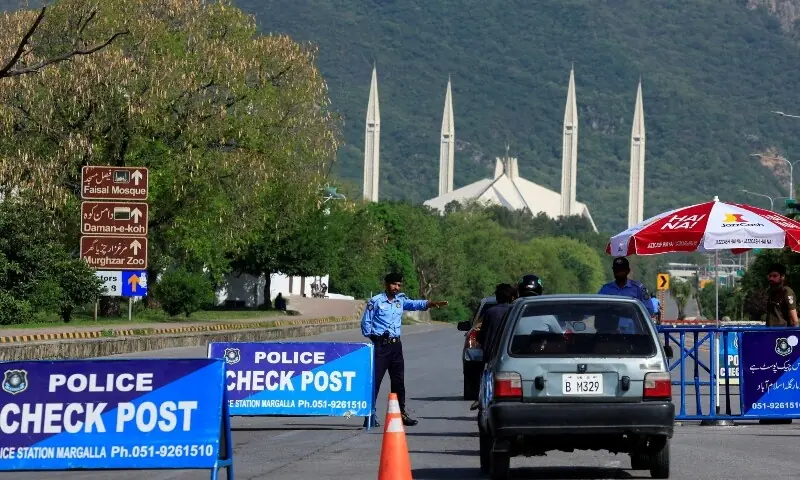 A police officer gestures to a vehicle at a check post along a road near Faisal Masjid, as Pakistan prepares to host the US and Iran for the second phase of peace talks in Islamabad, April 19. &mdash; Reuters