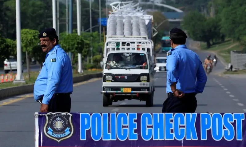Police officers stand at a security check post along a road, as Pakistan prepares to host the US and Iran for the second phase of peace talks in Islamabad, April 19. &mdash; Reuters