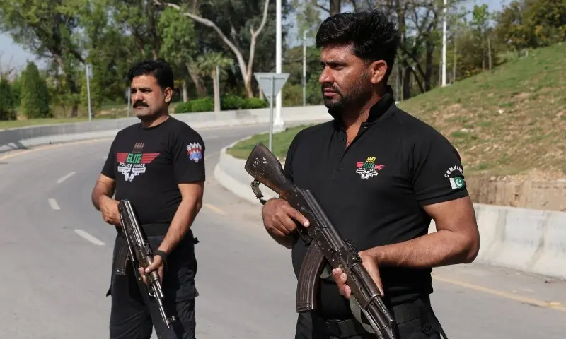 Police officers stand at a security checkpoint along a road, as Pakistan prepares to host the US and Iran for the second phase of peace talks in Islamabad, April 19. &mdash; Reuters