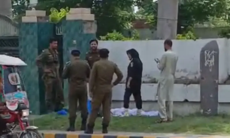 Police personnel gather outside Qur&rsquo;an & Sunnat Research Academy, where an armed attacker was shot after he opened fire, in Jhelum on April 19, 2026. &mdash; via Hamid Asghar