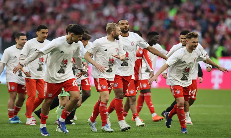 Munich: Bayern Munich players celebrate after sealing the Bundesliga title following their victory against VfB Stuttgart at the Allianz Arena on Sunday.&mdash;AFP
