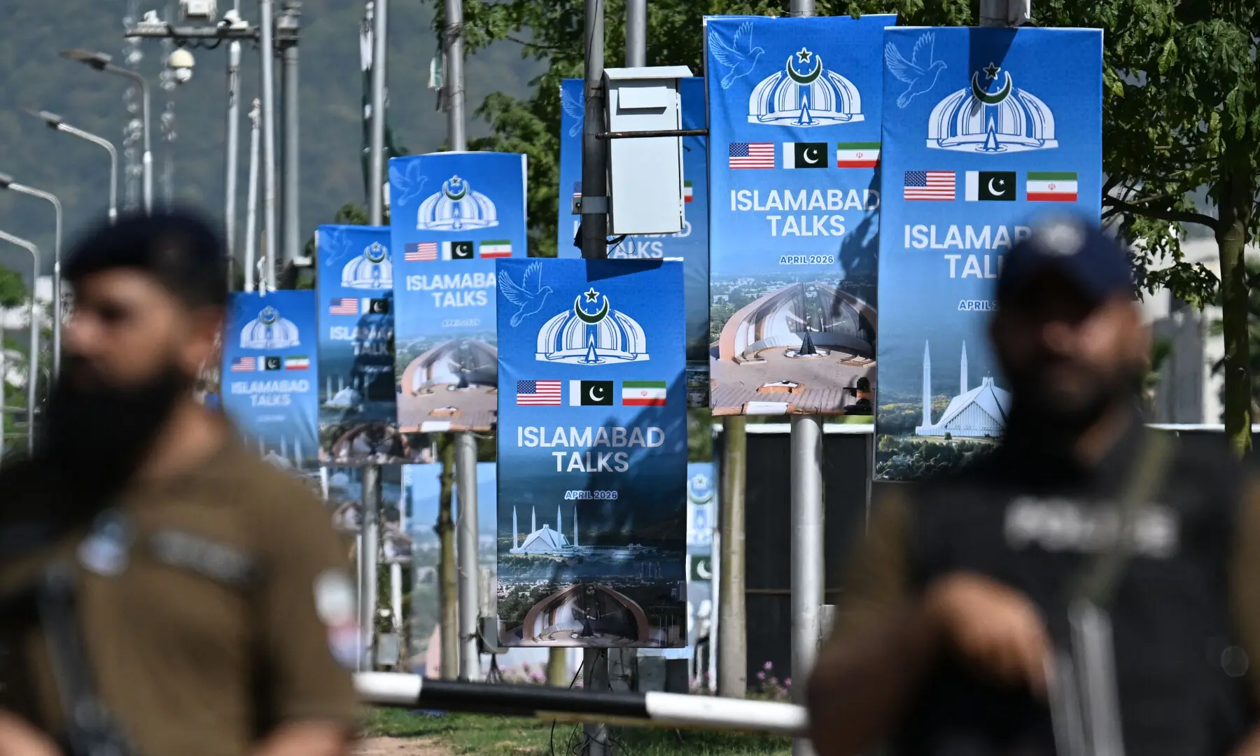 Security personnel stand guard at a security checkpost along a road temporarily closed near the Serena Hotel at the Red Zone area in Islamabad on April 20, 2026, ahead of anticipated US-Iran peace talks. &mdash; AFP