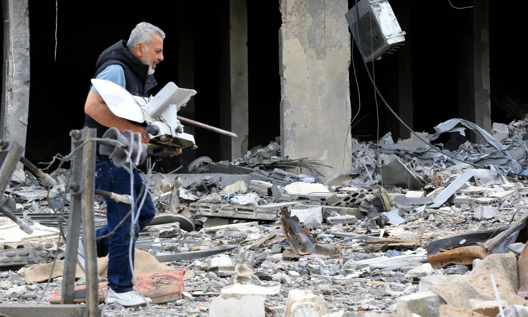 A man carries an item he salvaged from the rubble of a destroyed building after returning to the southern Lebanese city of Nabatieh on April 20, 2026. &mdash; AFP