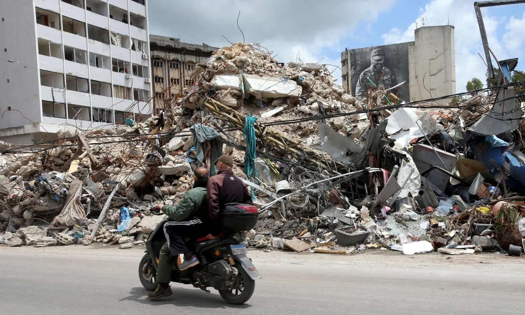 People ride a moped past the rubble of a destroyed building after returning to the southern Lebanese city of Nabatieh on April 20, 2026. &mdash; AFP